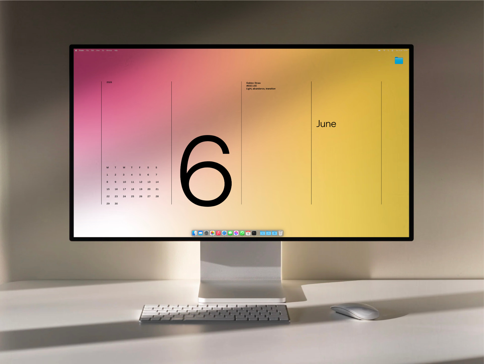 The June wallpaper running full-screen on a desktop Mac display